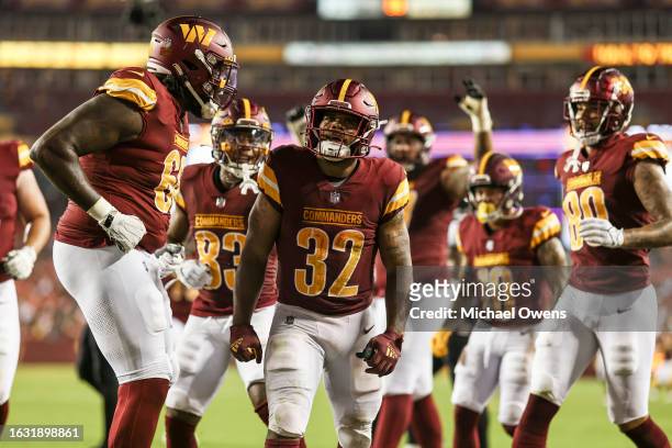 Jaret Patterson of the Washington Commanders celebrates with his teammates after scoring a touchdown against the Baltimore Ravens during an NFL...