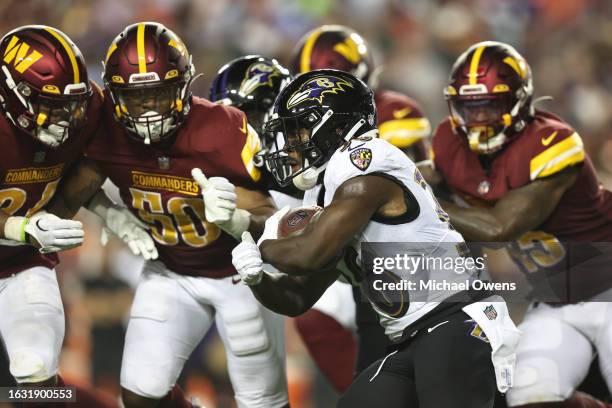 Owen Wright of the Baltimore Ravens runs with the ball during an NFL preseason game between the Washington Commanders and the Baltimore Ravens at...