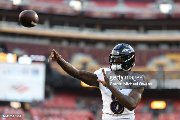 Lamar Jackson of the Baltimore Ravens passes as he warms up prior to an NFL preseason game between the Washington Commanders and the Baltimore Ravens...