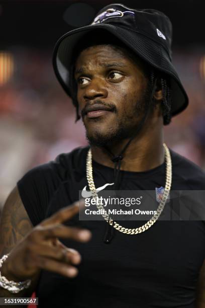 Lamar Jackson of the Baltimore Ravens reacts prior to an NFL preseason game against the Washington Commanders at FedExField on August 21, 2023 in...