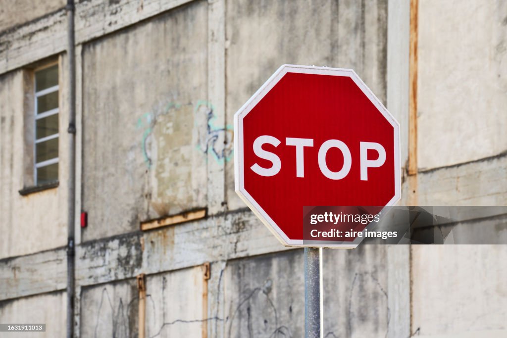 Stop Buildign Sign Side View Of A Metal Pole With A Red Stop Sign On The Street Outside A ...