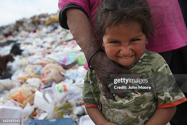 Mirna Guadelupe accompanies her grandmother who was searching for recyclables at the Tirabichi garbage dump on March 5, 2013 in Nogales, Mexico....