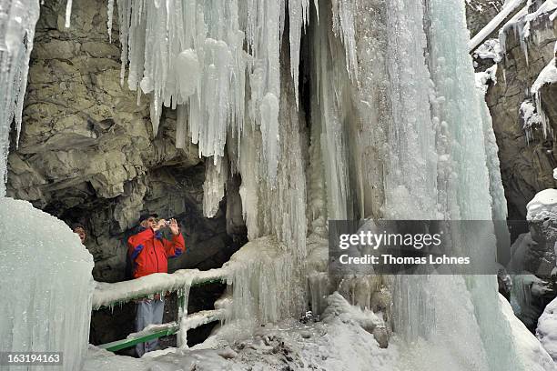 Visitor takes photographs of the winter ice in the Breitachklamm Canyon at Tiefenbach near Oberstorf on March 5, 2013 in Oberstdorf, Germany. The...