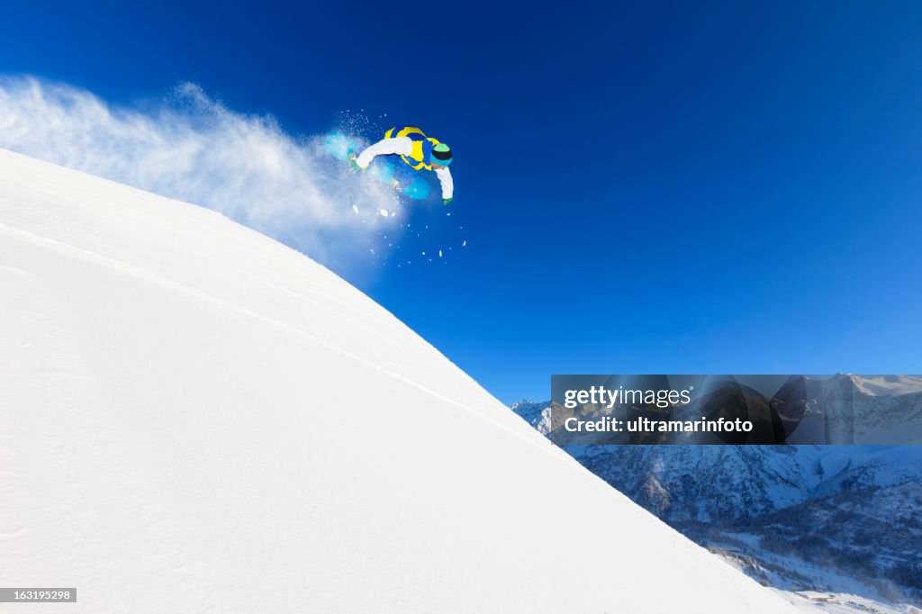 Freestyle snowboarder in a jump