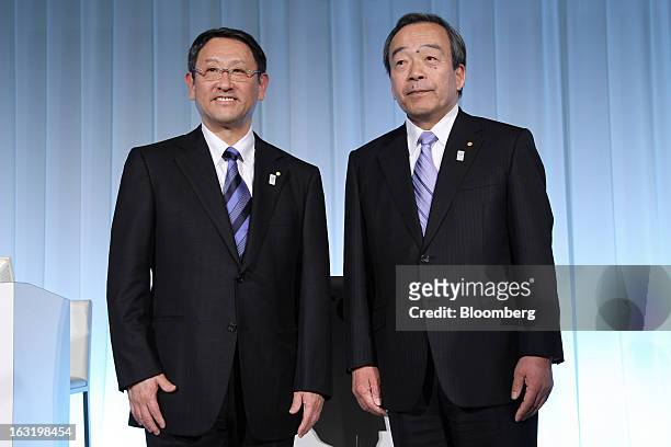 Akio Toyoda, president of Toyota Motor Corp., left, and Takeshi Uchiyamada, outgoing vice chairman and newly appointed chairman, stand for a...
