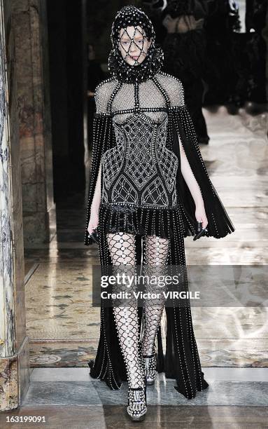 Model walks the runway during the Alexander McQueen Ready to Wear Fall/Winter 2013-2014 show as part of the Paris Fashion Week on March 05, 2013 in...