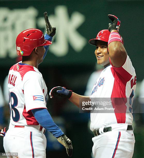 Outfielder Alfredo Despaigne of Cuba celebrates after hitting a home run during the World Baseball Classic First Round Group A game between Japan and...