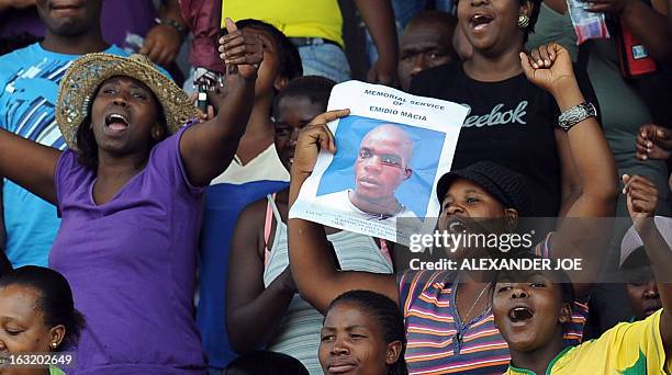 Friends, family and supporters of Mido Macia, a Mozambican man who died in custody after being dragged behind a South African police van, hold a...