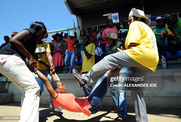 People reenact the way the police treated Mido Macia, a Mozambican man who died in custody after being dragged behind a South African police van,...