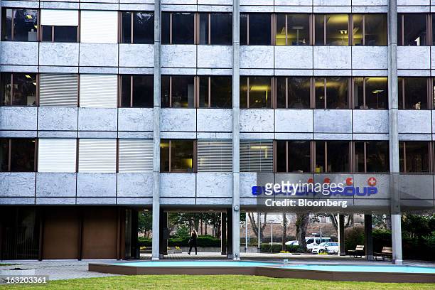 Logo sits above the entrance to the headquarters of Swatch AG in Bienne, Switzerland, on Wednesday, March 6, 2013. Swatch Group AG, the biggest maker...