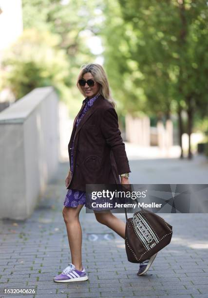Yasmin von Schlieffen-Nannen is seen wearing large sunglasses from Jimmy Choo, a suede brown long jacket from Blaze, a purple knee-length dress with...