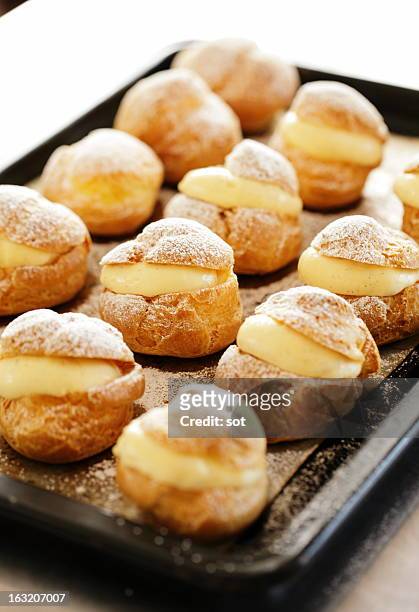 cream puffs on oven tray - cream cake stock pictures, royalty-free photos & images
