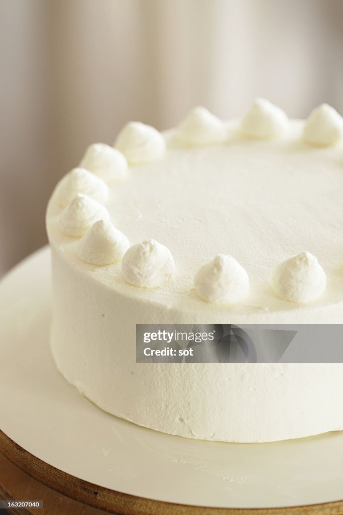 White cake decorated whipped cream