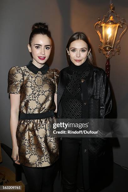 Lily Collins and Elisabeth Olsen attend the Louis Vuitton Fall/Winter 2013 Ready-to-Wear show as part of Paris Fashion Week on March 6, 2013 in...