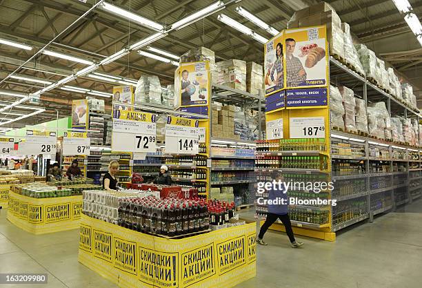 An employee walks past displays of alcohol in the aisle of a Lenta LLC supermarket in Prokopyevsk, Kemerevo region, Russia, on Wednesday, March 6,...