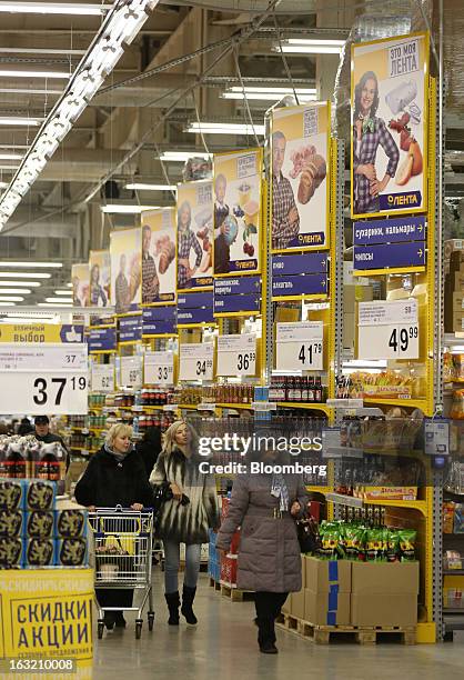 Shoppers pass through the food aisles inside a Lenta LLC supermarket in Prokopyevsk, Kemerevo region, Russia, on Wednesday, March 6, 2013. Lenta LLC,...