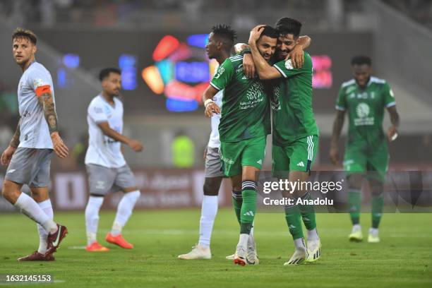 Riyad Mahrez of Al-Ahli Saudi FC celebrates with his teammate after scoring a goal during the Saudi Pro League week 4 match between Al-Ahli Saudi FC...