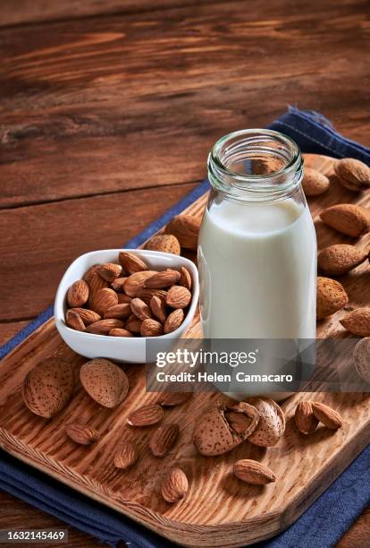 glass with almond milk on rustic wooden table with copy space - almond milk stock pictures, royalty-free photos & images