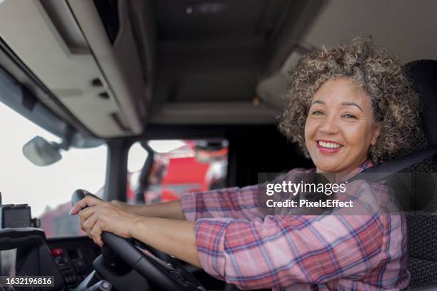 female truck driver looking at camera - trucker stock pictures, royalty-free photos & images