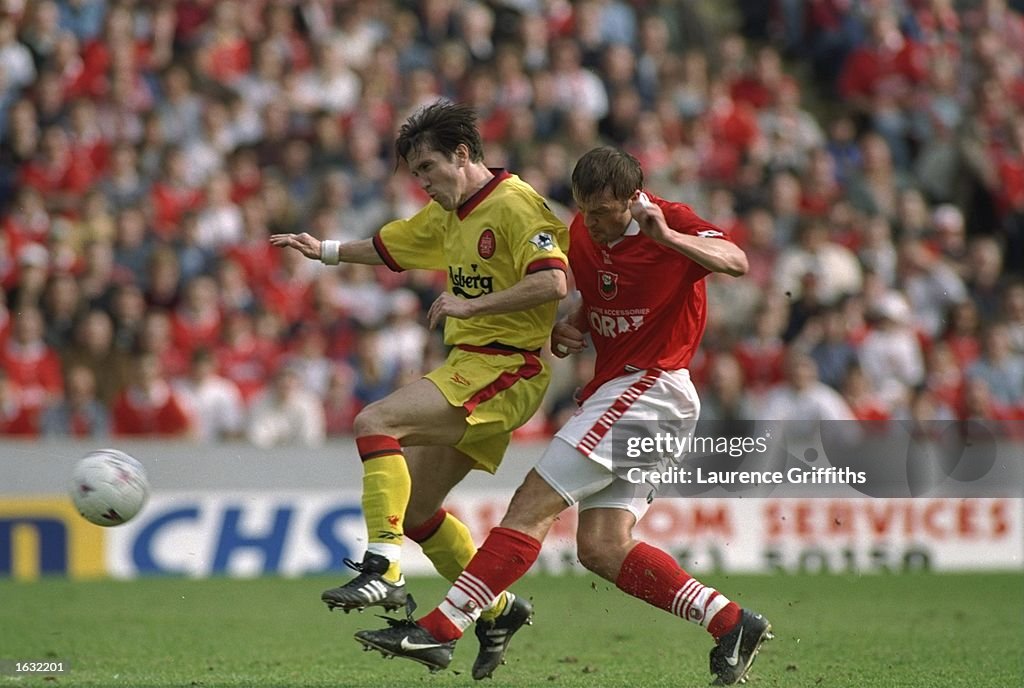 Neil Redfearn of Barnsley challenges Oyvind Leonhardsen of Liverpool