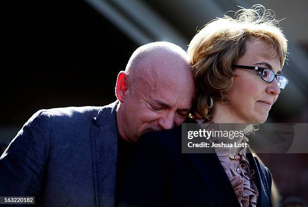 Mark Kelly leans his head on the shoulder of his wife and former Congresswoman Gabby Giffords as they attend a news conference asking Congress and...
