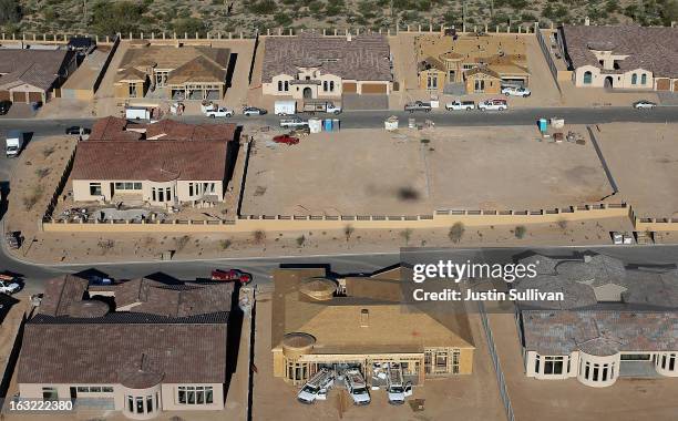 New homes are under construction at a housing development on March 6, 2013 in Mesa, Arizona. In 2008, Phoenix, Arizona was at the forefront of the...