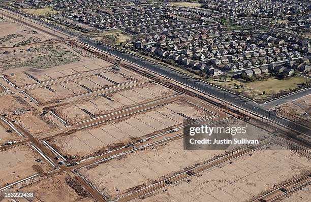 Empty parcels of land and unfinished roads sit next to a housing development on March 6, 2013 in Mesa, Arizona. In 2008, Phoenix, Arizona was at the...