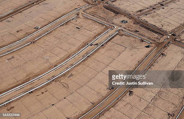 Empty parcels of land and unfinished roads are seen at a new housing development on March 6, 2013 in Mesa, Arizona. In 2008, Phoenix, Arizona was at...