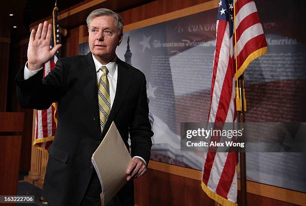 Sen. Lindsey Graham waves at the end of a news conference March 6, 2013 on Capitol Hill in Washington, DC. The senators held a news conference on...