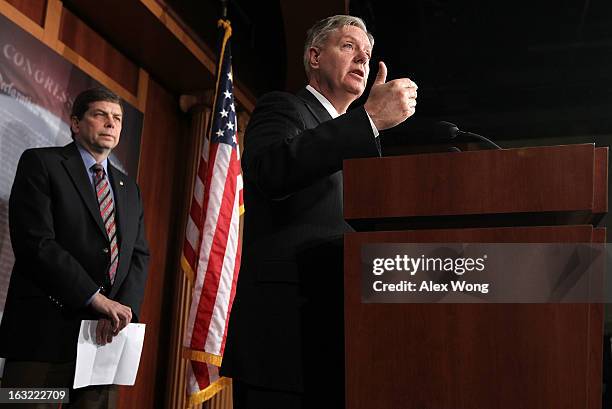 Sen. Lindsey Graham speaks as Sen. Mark Begich listens during a news conference March 6, 2013 on Capitol Hill in Washington, DC. The senators held a...