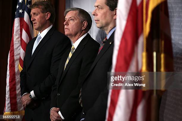 Sen. Lindsey Graham , Sen. Mark Begich , and Sen. Jeff Flake listen during a news conference March 6, 2013 on Capitol Hill in Washington, DC. The...