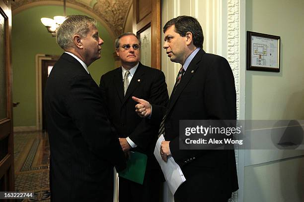 Sen. Lindsey Graham and Sen. Mark Pryor listen to Sen. Mark Begich prior to a news conference March 6, 2013 on Capitol Hill in Washington, DC. The...