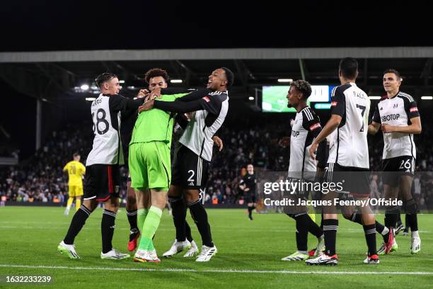 Kenny Tete of Fulham celebrates with goalkeeper Marek Rodak after they win on penalties during the Carabao Cup Second Round match between Fulham and...