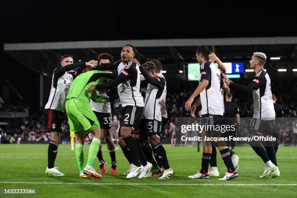 Kenny Tete of Fulham celebrates with goalkeeper Marek Rodak after they win on penalties during the Carabao Cup Second Round match between Fulham and...