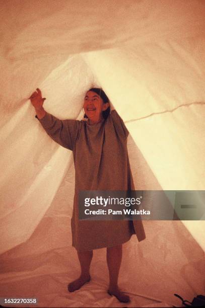 German-born music educator Charlotte Selver smiles as she holds up a tent while leading a Sensory Awareness workshop at the Esalen Institute, Big...