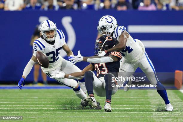 Nsimba Webster of the Chicago Bears attempts to catch a pass while defended by Teez Tabor and Chris Lammons of the Indianapolis Colts in the fourth...