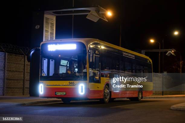 yutong u12 on the bus loop at night - warsaw bus stock pictures, royalty-free photos & images