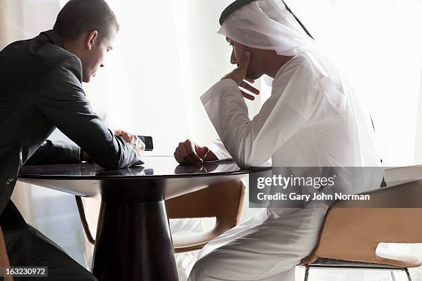 two middle eastern businessmen having meeting - united arab emirates culture stock pictures, royalty-free photos & images