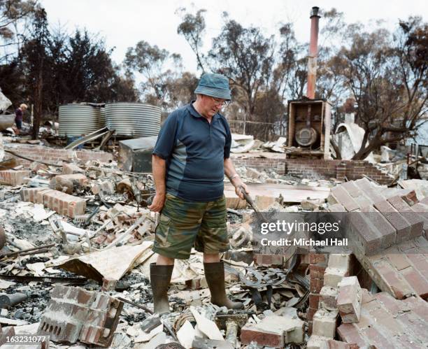 homeowner amongst ruins of burnt house - ruined clothes stock pictures, royalty-free photos & images