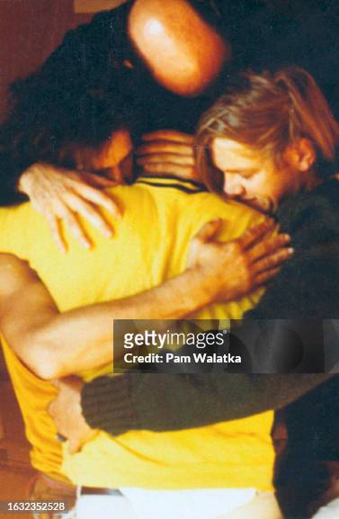 View of, clockwise from top, psychologist Will Schutz, Steve Stroud, Bennett Shapiro , and Seymour Carter as they hug during a support group at the...