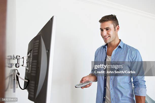 Man Using Remote Control Man Standing With Tv Remote Photos and Premium High Res Pictures ...