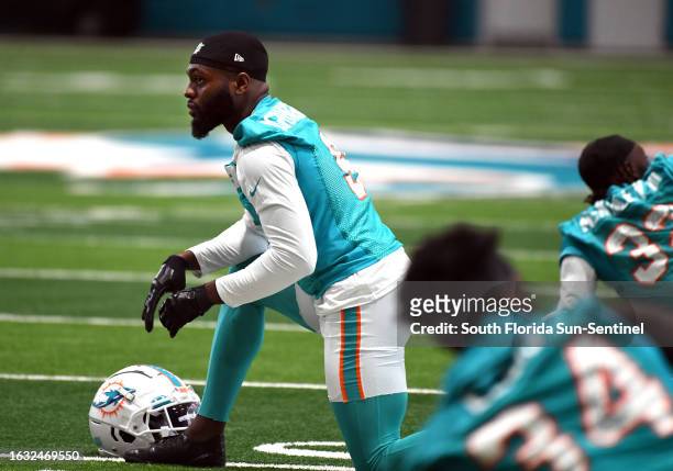 Miami Dolphins' Noah Igbinoghene stretches at minicamp at the Dolphins training faciilty in Miami Gardens, Florida, Tuesday, June 6, 2023.