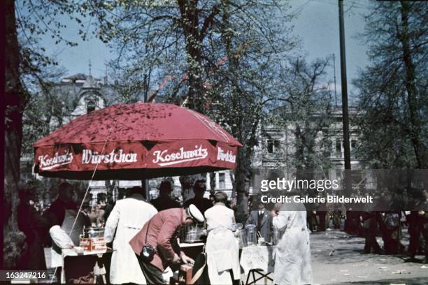 Street vendor selling Koschwitz sausages in downtown Berlin. 1st May 1937. At the Lustgarten, Adolf Hitler , chancellor of Germany, delivered a...