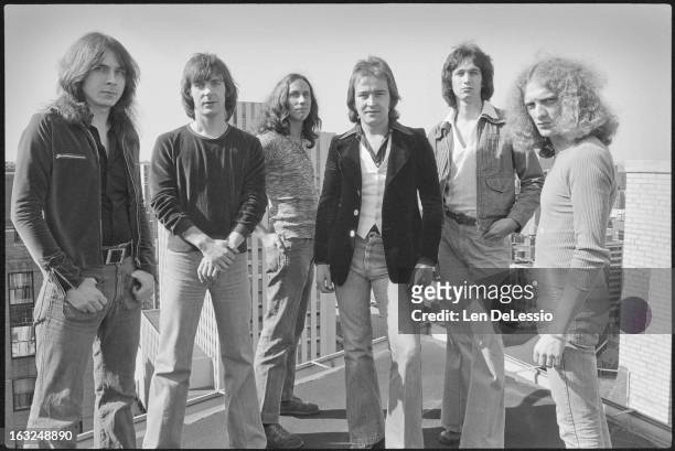 Group portrait of the British & American rock band Foreigner as they pose together on a rooftop, New York, New York, 1976. Pictured are, from left,...