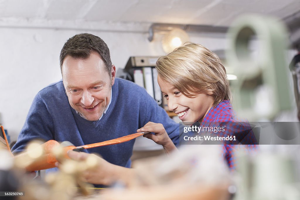 Germany, Leipzig, Father and son repairing toy plane