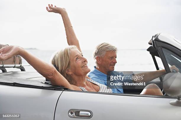 spain, senior couple in convertible car, smiling - westend61 fotografías e imágenes de stock