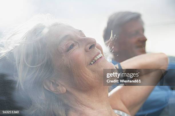 spain, senior couple in convertible car, smiling - auto alt stock-fotos und bilder