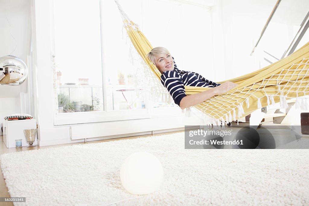 Germany, Bavaria, Munich, Woman relaxing in hammock