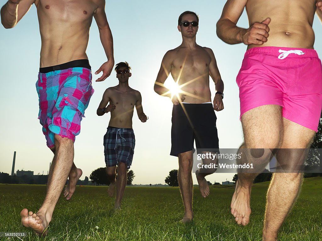 Germany, Duesseldorf, Young friends running on meadow