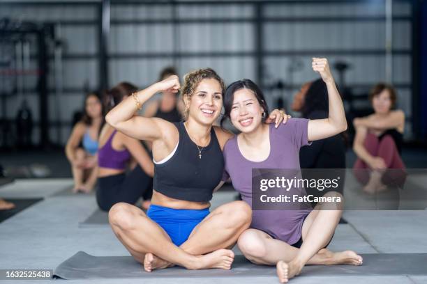 feeling strong - group of people flexing biceps stock pictures, royalty-free photos & images